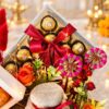 Ferrero Rocher 24-piece box with red satin bow and pink Shubh Labh hangings, close-up