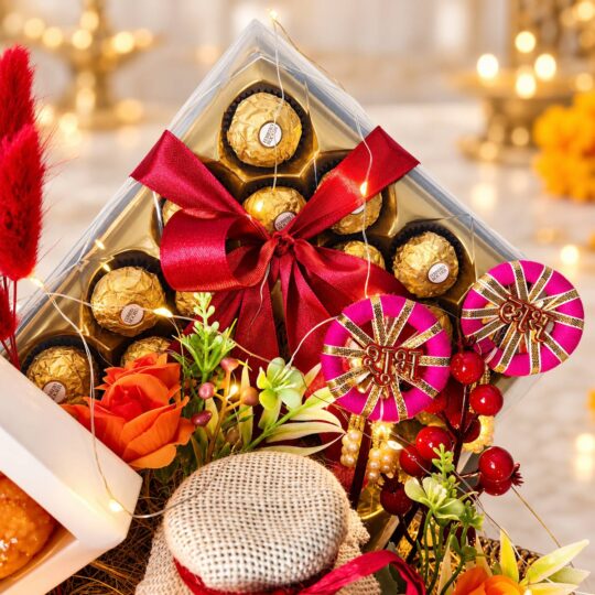 Ferrero Rocher 24-piece box with red satin bow and pink Shubh Labh hangings, close-up