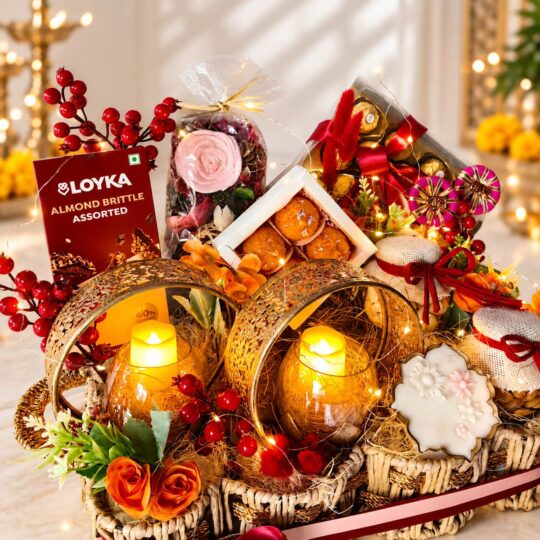Rope basket Diwali hamper with gold jaali candle holders, laddoo candles and Ferrero Rocher, close front view