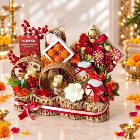 Diwali gift basket in Bangalore with Ferrero Rocher, almonds, cashews, scented candles and gold candle holders in a rope basket