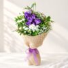 Exotic cut flowers in Bangalore with purple lisianthus, white spray carnations, chrysanthemums and santini in natural jute wrap