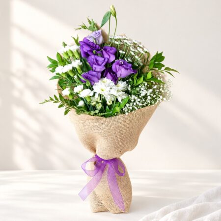 Exotic cut flowers in Bangalore with purple lisianthus, white spray carnations, chrysanthemums and santini in natural jute wrap
