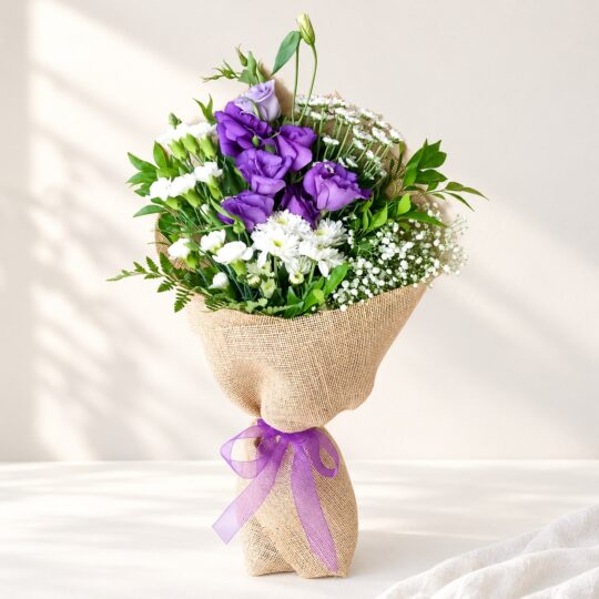 Exotic cut flowers in Bangalore with purple lisianthus, white spray carnations, chrysanthemums and santini in natural jute wrap