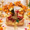 Diwali hamper with diyas in Bangalore with a peacock panch diya, clay diyas, pistachios, raisins and dark chocolate in a cane basket