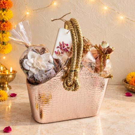 Diwali dry fruit potli hamper in Bangalore with cashew and almond potlis, potpourri and wax sachet in a rose gold bag