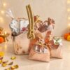 Contents of the Noor gift bag with potpourri pack, rose petal wax sachet, two rose gold potlis and the empty rose gold bag