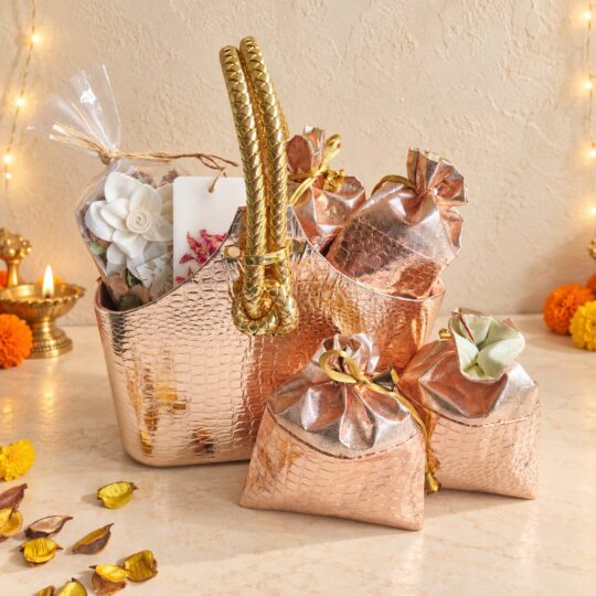 Contents of the Noor gift bag with potpourri pack, rose petal wax sachet, two rose gold potlis and the empty rose gold bag